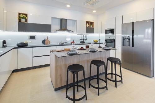 a kitchen with a large island with two bar stools at Almyriki Beach Villa in Monolithos