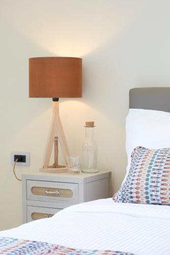 a bedroom with a bed and a lamp on a night stand at Almyriki Beach Villa in Monolithos