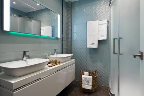 a bathroom with a sink and a mirror at Almyriki Beach Villa in Monolithos