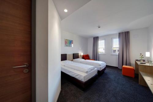 Postel nebo postele na pokoji v ubytování Euro Hotel Friedberg