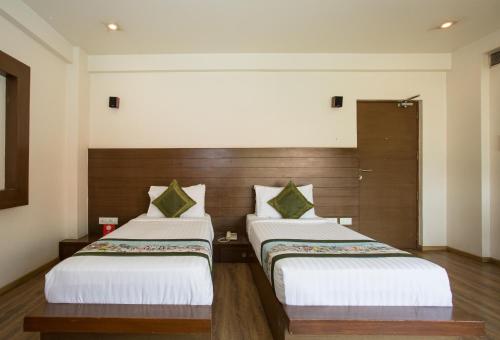 a hotel room with two beds in a room at Corporate Stay in Pune