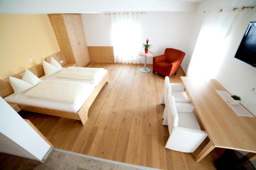 a room with a bed and a couch and a table at Landhaus Essl in Dietach