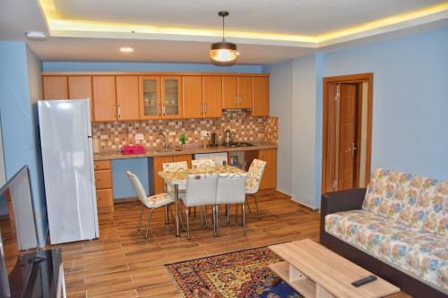 a kitchen and living room with a table and a couch at Badul Apart in Uzungöl