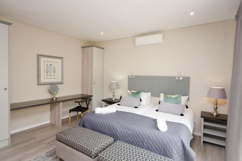 Ένα ή περισσότερα κρεβάτια σε δωμάτιο στο Du Kloof Lodge