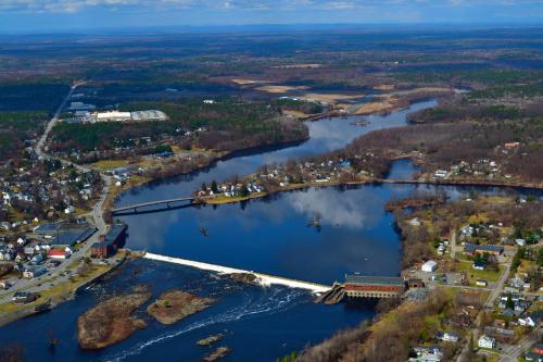 an aerial view of a river with a bridge at Black Bear Inn, an Ascend Collection Hotel in Orono