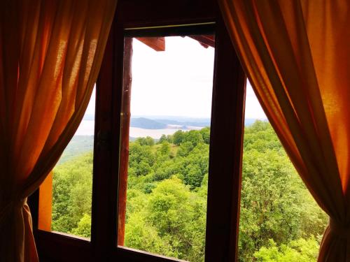 a window with a view of a forest at Hotel Loggas in Kastoria