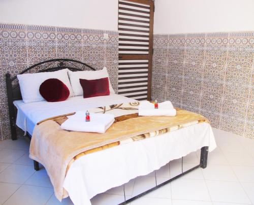 a bedroom with two beds with towels on them at Riad De Rêve in Zagora