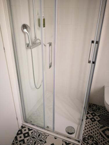 a shower with a glass door in a bathroom at Hotel Villa Rina in Riva del Garda