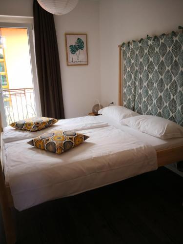 a large bed with two pillows on top of it at Hotel Villa Rina in Riva del Garda