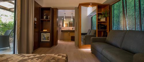a living room with a couch and a living room with at Baglio La Porta by Geocharme in San Vito lo Capo