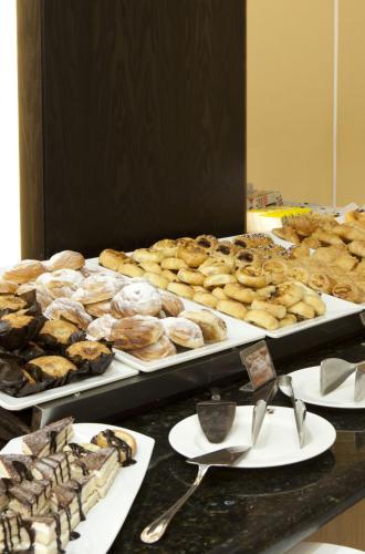 a buffet of different types of donuts and other pastries at Hotel Cordoba Center in Córdoba