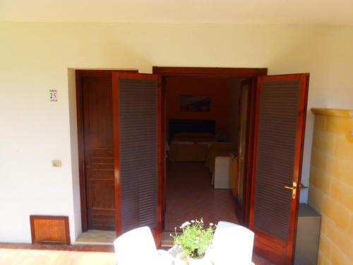 a hallway with two doors and a room with a bed at Missipezza Residence a Frassanito in Alimini