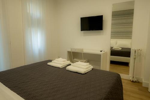 a bedroom with a bed with towels on it at Suite Pinturicchio in Rome