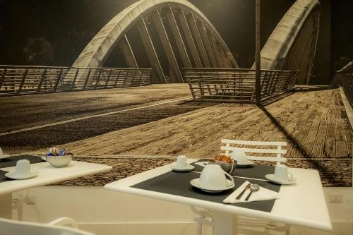 a dining table with a view of a bridge at Suite Pinturicchio in Rome