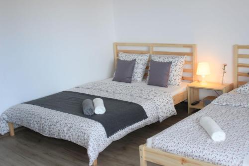 a bedroom with two beds with pillows at Pokoje i Apartamenty na Szkolnej in Zator