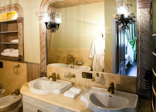 a bathroom with two sinks and a large mirror at Villa Toscana in Kaliningrad