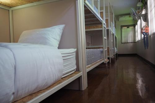 a room with a bed and a bunk room with a ladder at Insight Hostel in Chiang Mai