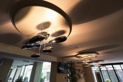 a row of lights hanging from a ceiling at Hotel Zena Beauty & Shopping Center in Hévíz