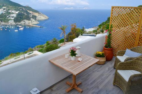 a balcony with a table and a view of the ocean at Maridea Casa Vacanza- Le Alcove sul Mare Suites in Ponza
