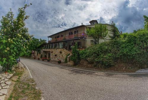 a house on the side of a road at Guesthouse Mavrodimos in Eptalofos