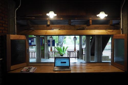 a laptop sitting on a table in front of a window at Insight Hostel in Chiang Mai
