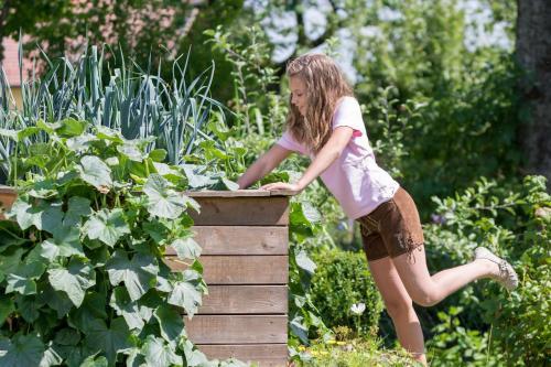 a girl is jumping off of a wooden box at Pension Zum Ebenstein am Donausteig in Untergriesbach