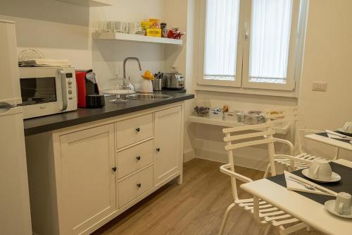 a kitchen with a microwave and a counter top at Suite Pinturicchio in Rome
