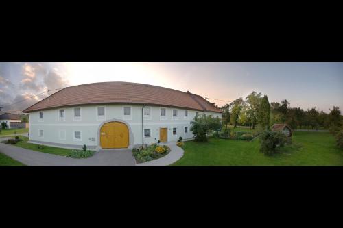 a large white house with a brown roof at Landhaus Essl in Dietach