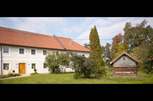 a large white house with an orange roof at Landhaus Essl in Dietach