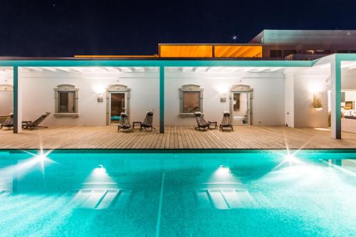 a view of a swimming pool at night at Conversas de Alpendre in Vila Nova de Cacela