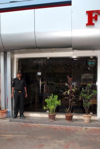 a police officer standing in the doorway of a building at Hotel Fortune in Mumbai