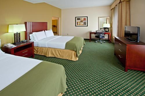 a hotel room with two beds and a flat screen tv at Holiday Inn Express & Suites Indianapolis - East, an IHG Hotel in Indianapolis