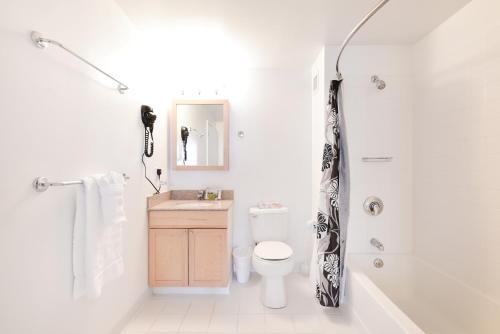 a white bathroom with a toilet and a shower at Global Luxury Suites at Kendall West in Cambridge