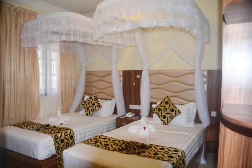 Katil atau katil-katil dalam bilik di Spice Palace Hotel