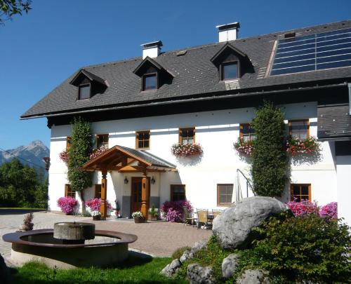 a large white building with a fountain in front of it at Ferienhof Grossgrub in Vorderstoder