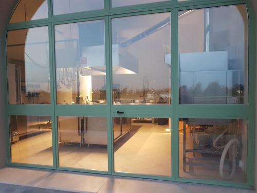 a large window in a building with a view of a room at Fattoria L'Olmetto in Pisa