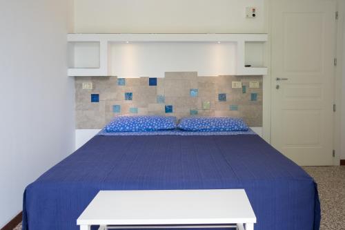 A bed or beds in a room at Locanda Villa Fiori