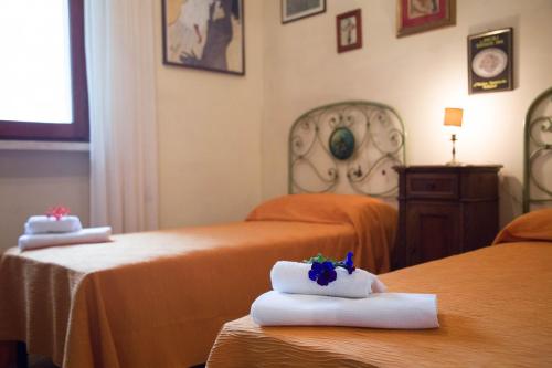 a hotel room with two beds with towels on them at POGGIO ECO B&B in Ascoli Piceno