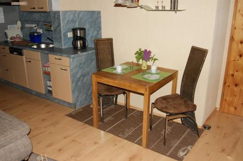 a dining room table and chairs in a kitchen at Landhaus Lex in Füssen