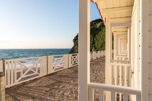 a view of the ocean from a house doorway at Tolcarne Beach Colonial Restaurant and Rooms in Newquay