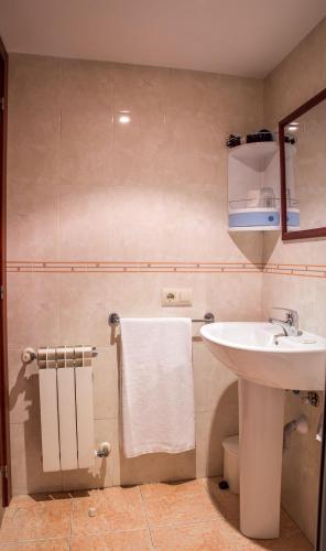 a bathroom with a white sink and a mirror at Hostal Hotil Coruña Centro in A Coruña