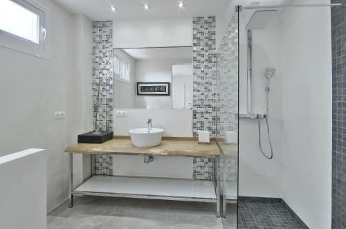 a bathroom with a sink and a shower at Can Garchet White Ibiza in Sant Jordi