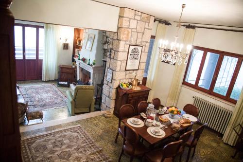 a living room with a table and a stone fireplace at POGGIO ECO B&B in Ascoli Piceno