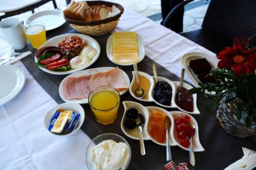 a table with breakfast foods and drinks on it at Apartments Despina in Sinarádes