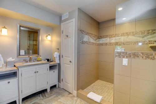 a bathroom with a shower and a sink at Winchester Inn in Ashland