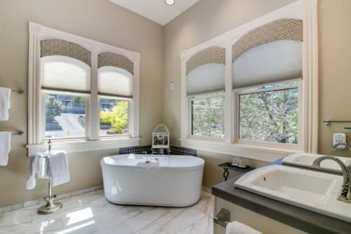 a large bathroom with a large tub and windows at Winchester Inn in Ashland