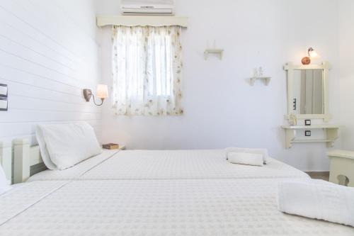 Ένα ή περισσότερα κρεβάτια σε δωμάτιο στο Villa Faros Luxury Apartments & Suites