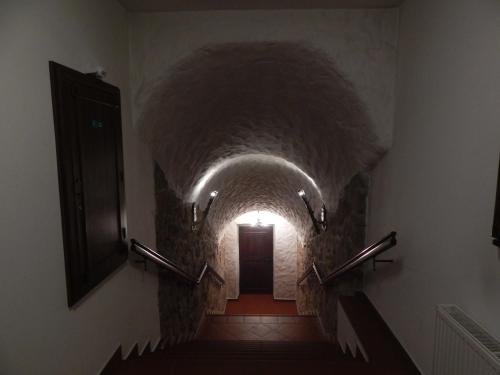 a long hallway with a tunnel in a building at Hotel Zámeček Pod Hradem Starý Jičín 111 in Starý Jičín