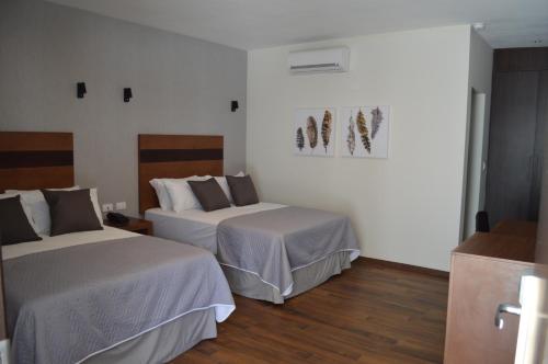 Ένα ή περισσότερα κρεβάτια σε δωμάτιο στο Hotel Plaza Catedral