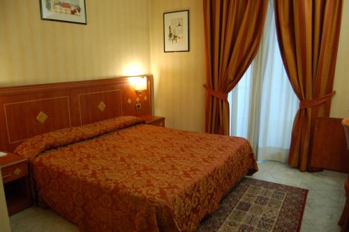 Postel nebo postele na pokoji v ubytování Hotel Chelsea